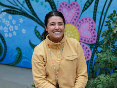 Young female teacher sits and smiles