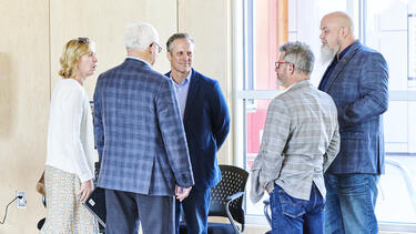 Five Adults in a Circle Talking