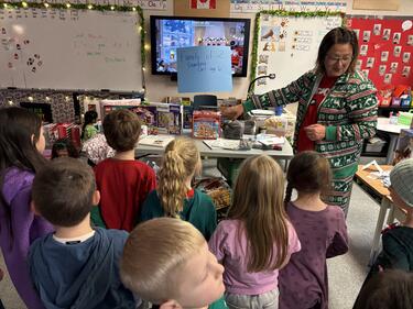 Teacher showing students donation items