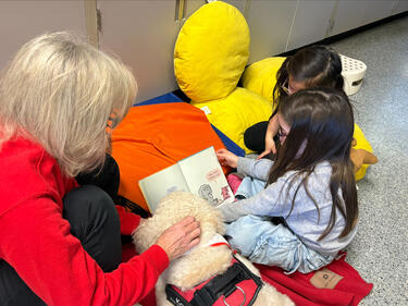 Students Reading with Kona