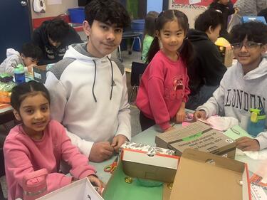 High School Buddies Helping to Make Leprechaun Traps in Kindergarten