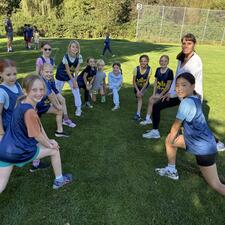 Girls Cross Country Stretching with Coach